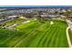 Expansive golf course aerial featuring manicured greens, sand traps, and golf carts at 3 Bermuda Cir # 49, Englewood, FL 34223