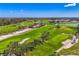 Aerial view of the golf course, showcasing lush green fairways and landscaping with golf carts ready for the next round at 3 Bermuda Cir # 49, Englewood, FL 34223