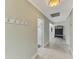 Spacious hallway with tiled floors, white trim, and ample storage, offering seamless flow between rooms at 3 Bermuda Cir # 49, Englewood, FL 34223
