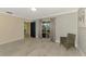 Well-lit hallway with tiled floors and a view through to an adjacent room at 3 Bermuda Cir # 49, Englewood, FL 34223