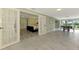 Hallway with views to bedroom and sunroom, tiled floors, and bright lighting at 3 Bermuda Cir # 49, Englewood, FL 34223