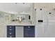 Open-concept kitchen with stainless refrigerator and bar seating with stone countertop at 3 Bermuda Cir # 49, Englewood, FL 34223