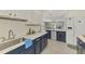 Well-lit kitchen with stainless steel sink, stone countertops, and open floor plan concept at 3 Bermuda Cir # 49, Englewood, FL 34223