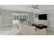 Living room features large windows, a ceiling fan, and neutral color palette at 3 Bermuda Cir # 49, Englewood, FL 34223
