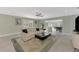 Bright living room featuring a ceiling fan, plantation shutters, and tiled floors, perfect for relaxing or entertaining at 3 Bermuda Cir # 49, Englewood, FL 34223