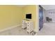 Bright office room with a desk, TV, tile floors, and an entry at 3 Bermuda Cir # 49, Englewood, FL 34223