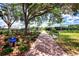 Beautiful walkway for racquet and golf members featuring gorgeous foliage and a shaded canopy at 3 Bermuda Cir # 49, Englewood, FL 34223
