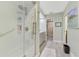 White tiled shower featuring a shower caddy, shower head, and hand bar at 3 Bermuda Cir # 49, Englewood, FL 34223