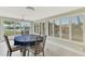 Sunroom with outdoor views through windows and sliding door, plus dining area at 3 Bermuda Cir # 49, Englewood, FL 34223
