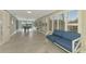 Bright sunroom with tiled floors, couch, and large windows overlooking the yard at 3 Bermuda Cir # 49, Englewood, FL 34223