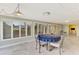 Sunroom with dining table, large windows with shutters, and backyard view at 3 Bermuda Cir # 49, Englewood, FL 34223