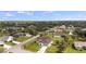 Aerial view of homes and property featuring lush greenery, tropical trees, and blue skies at 3084 Brockton St, North Port, FL 34286