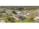 Aerial view of a neighborhood home featuring a screened pool, solar panels, and mature landscaping at 3084 Brockton St, North Port, FL 34286