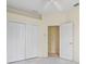 Bedroom featuring double closets, a ceiling fan, and a doorway at 3084 Brockton St, North Port, FL 34286