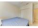 A simple bedroom with a comfortable bed, closet, and fan at 315 Southland Rd, Venice, FL 34293