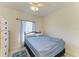 Bright bedroom with a ceiling fan, window, and tile flooring at 315 Southland Rd, Venice, FL 34293