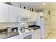 Bright kitchen featuring white appliances, light countertops, and ample storage at 315 Southland Rd, Venice, FL 34293