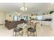 Bright dining area with a modern glass table adjacent to the living room and kitchen at 315 Southland Rd, Venice, FL 34293