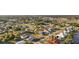 Aerial view of property showcasing the home's location and landscaping in a residential neighborhood with canal access at 3265 Sunrise Trl, Port Charlotte, FL 33952