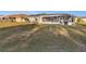 Large backyard featuring a screened lanai, offering ample space for recreation and leisure at 3265 Sunrise Trl, Port Charlotte, FL 33952