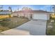 Charming single-story home featuring an attached garage and well-maintained front yard at 3265 Sunrise Trl, Port Charlotte, FL 33952