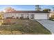 Charming single-story home with a well-maintained lawn and inviting curb appeal under a bright sky at 3265 Sunrise Trl, Port Charlotte, FL 33952