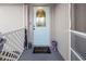 Welcoming covered front porch featuring a decorative door, owl statue, and cute decor at 3265 Sunrise Trl, Port Charlotte, FL 33952