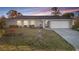 Charming single-story home featuring a well-maintained front yard and attached garage with a long driveway at 3265 Sunrise Trl, Port Charlotte, FL 33952