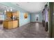 Bright living room featuring wood-look floors, an open floor plan, and light-colored walls flowing into the kitchen at 3265 Sunrise Trl, Port Charlotte, FL 33952