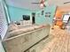 This living room features wood-look tile flooring and opens to the kitchen at 3265 Sunrise Trl, Port Charlotte, FL 33952