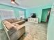 The living room features wood-look tile flooring and neutral furniture at 3265 Sunrise Trl, Port Charlotte, FL 33952
