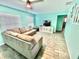 The living room features wood-look tile flooring and neutral furniture at 3265 Sunrise Trl, Port Charlotte, FL 33952