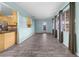 Spacious living room featuring wood-look floors and natural light from multiple windows at 3265 Sunrise Trl, Port Charlotte, FL 33952