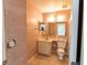 Cozy bathroom with a pedestal sink, tile floors, medicine cabinet, and a standard toilet at 3300 Loveland Blvd # 2103, Punta Gorda, FL 33980