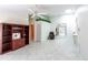 Bright living room with tiled floors, ceiling fan, and a view of the outdoor patio area at 3300 Loveland Blvd # 2103, Punta Gorda, FL 33980