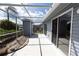 Enclosed patio with sliding glass doors, light grey siding, and a manicured yard with landscaping at 3300 Loveland Blvd # 2103, Punta Gorda, FL 33980