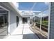 Enclosed patio with sliding glass doors and light grey siding looks out onto a meticulously maintained yard at 3300 Loveland Blvd # 2103, Punta Gorda, FL 33980