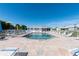 Community swimming pool featuring chairs and umbrellas, offering a relaxing atmosphere at 3300 Loveland Blvd # 2103, Punta Gorda, FL 33980