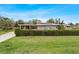 Charming single-story home featuring a manicured lawn and vibrant green hedges in a peaceful neighborhood at 3624 Dawson Ln, Punta Gorda, FL 33950