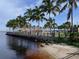 Picturesque waterfront view with palm trees, sandy beach, and clear skies at 3624 Dawson Ln, Punta Gorda, FL 33950