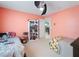 View of a secondary bedroom featuring two beds, ceiling fan and view into the entry hall at 4461 Baroda Ave, North Port, FL 34287