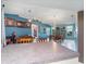 Open dining room with blue accent walls, tile floors and modern pendant lighting at 4461 Baroda Ave, North Port, FL 34287