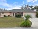 Charming single-story home with a well-manicured lawn and a convenient attached garage at 4461 Baroda Ave, North Port, FL 34287