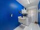 Laundry room in a vibrant blue with modern washer and dryer at 4461 Baroda Ave, North Port, FL 34287