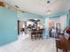 Living room with tile floors leading into an open kitchen, dining area and sliding glass doors to the backyard at 4461 Baroda Ave, North Port, FL 34287