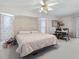 Bright main bedroom with a king bed, light-colored walls, carpet and an office space at 4461 Baroda Ave, North Port, FL 34287
