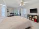 Main bedroom with a king bed, light-colored walls, carpet and an office space, leading to an outdoor patio at 4461 Baroda Ave, North Port, FL 34287