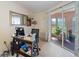 Bright office space with a desk, chair, a mirror and a sliding glass door leading to an outdoor patio at 4461 Baroda Ave, North Port, FL 34287