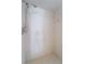 White tiled walk-in shower with handheld shower head in neutral bathroom at 4461 Baroda Ave, North Port, FL 34287