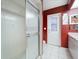 Walk-in shower adjacent to a vanity and access door to the exterior at 4461 Baroda Ave, North Port, FL 34287